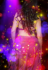 Fototapeta na wymiar Belly Dancer wearing purple dance costume close up with bokeh