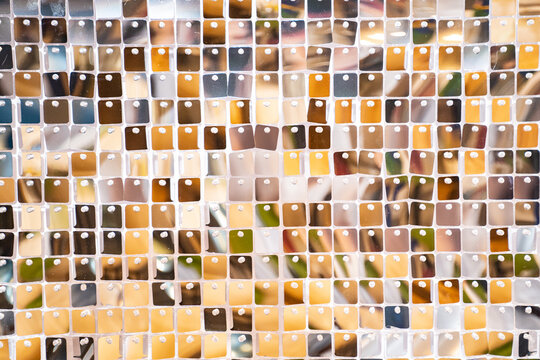 wall made of many square sparkling sequins. event decoration on photo zone. bright abstract background swaying in the wind