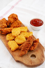 Tasty Fastfood: Chicken Nuggets, Wings and Tenders with Ketchup, side view. Copy space.