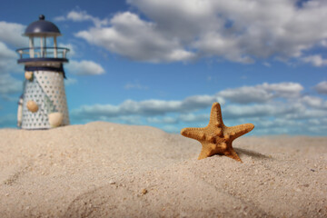 Fototapeta na wymiar Lighthouse With Seashell on Beach, Close up on Shell