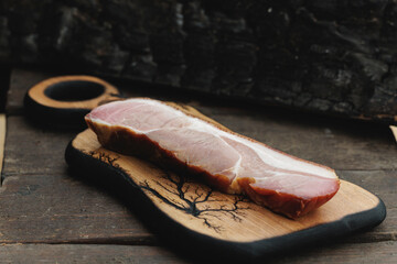 Best pork ham is home-made, traditionally rustic dish, on a hand-made wood derving or cutting board