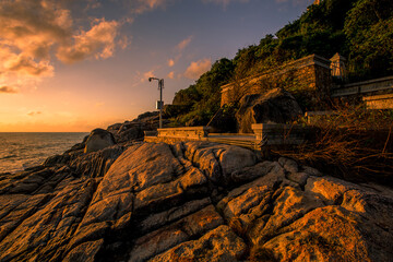 The background of the sea by the evening sea, with natural beauty (sea water, rocks, sky) and fishermen are fishing by the river bank, is a pleasure during travel.