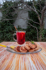 red hibiscus tea with orange, lemon and cinnamon and syrniki