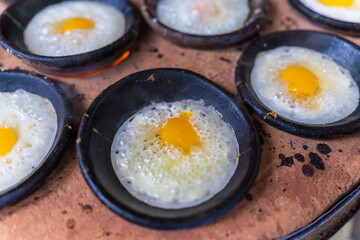 Vietnamese Street Food in Da Lat city, Vietnam - Banh can on the warm ember stove kitchen. Food and travel concept.