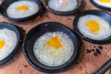 Vietnamese Street Food in Da Lat city, Vietnam - Banh can on the warm ember stove kitchen. Food and travel concept.