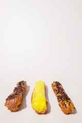 French eclairs with choclate top and different fillings. Traditional recipe, French cuisine.