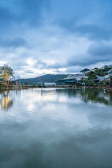 Fototapeta na wymiar An Son Ho lake in sunset, Da Lat, Viet Nam. Beautiful landscape with clouds and misty. Panorama