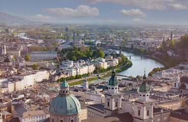 Panoramic view in a Spring season  scene at a historic city of Salzburg with Salzach river in beautiful golden evening light sky at sunset, Salzburger Land, Austria.