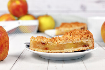 Side view of slice of traditional European apple pie with topping crumbles called 'Streusel'