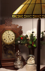 Vintage Lamp With Antique Clock in Background Shallow DOF