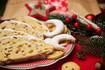 Slices of Traditional Christmas stollen cake with marzipan and New Year decorations