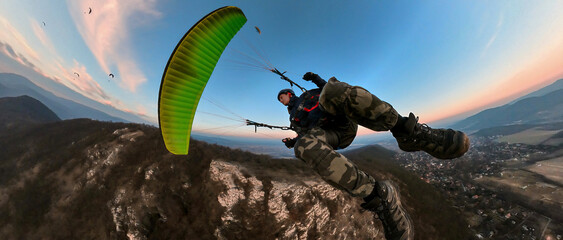Man flying the paragliding at sunset, adventure concept - obrazy, fototapety, plakaty
