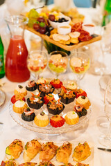 tartlets with salads, snacks and drinks. convenient serving of snacks for the buffet. catering for the holiday.