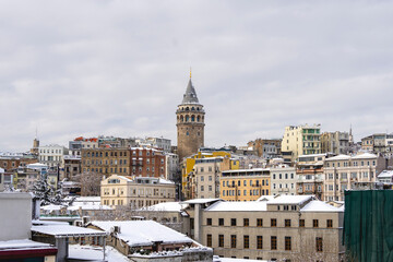 Fototapeta premium Galata Tower on winter day covered with snow. Galata Tower is a medieval stone tower in the Galata quarter of Istanbul, Turkey.