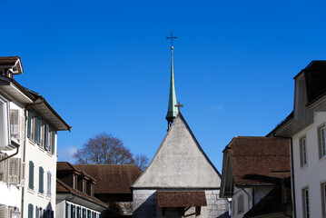 Fototapeta na wymiar Historic houses with St. Peter Chapel at the old town of Solothurn on a sunny winter day. Photo taken February 7th, 2022, Solothurn, Switzerland.