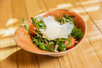 Arugula tomato salad with shaved parmesan cheese