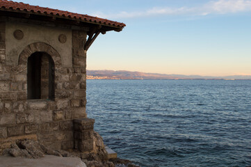 Stone lookout building on the lungomare coastal promenade, from the period of Franz Joseph I, built in 19th century, famous walkway connecting Volosko with Opatija and Lovran, view on the city Rijeka,