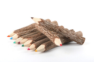Colorful crayons made of rough and unprocessed wood isolated on white
