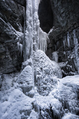 Breitachklamm Alps - snow and dramatic frozen ice covered paths within a gorge and frozen waterfall