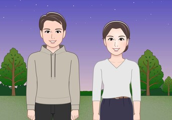 夜の公園にいる若い男女