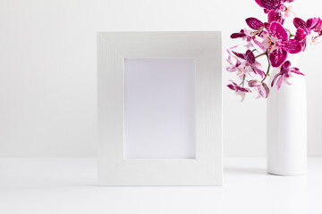 Beautiful flowers composition. Bouquet of pink orchids in vase on  table. Photo frame, pink orchid flower on white background. Concept Valentines Day, Happy Women's Day, March 8. 