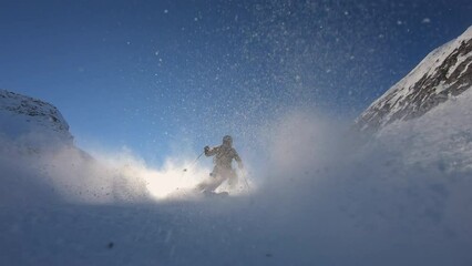 High speed ski turns on a steep ski slope in a glacier ski resort high up in the alps with fresh snow. Panorama skiing with the best mountain. Cinematic slow motion skiing in winter. 4K PRORES 422