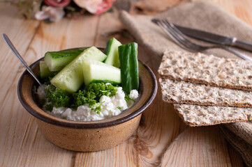 Homemade healthy meal or snack with cottage cheese, vegetable, herbs and cripbread