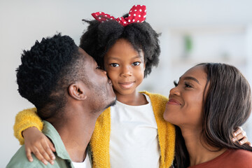 Portrait Of Happy Black Family, Young Parents And Cute Little Daughter