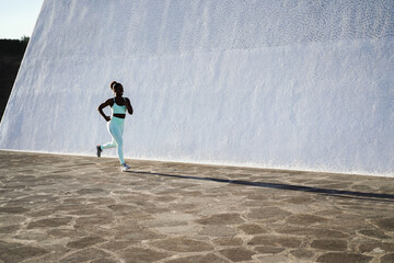 Fit african woman running outdoor - Focus on face