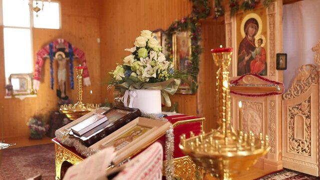 View at the Many ortodox Church Candles Burning in the Temple. The Holy bible, font for the sacrament , Orthodox item, Orthodox cross in church, Christianity concept