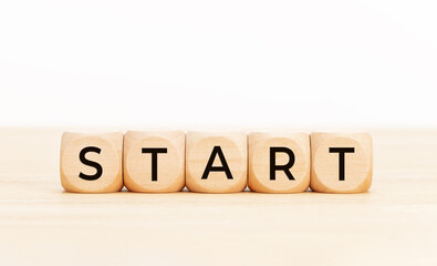 Start word on wooden block shape. Copy space. White background