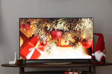 Modern TV and Christmas decor on table indoors