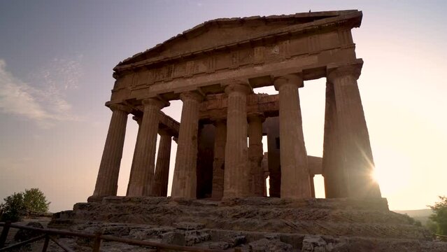 Panning on greek temple of Concordia in the Valle dei Templi at sunset, Italy.