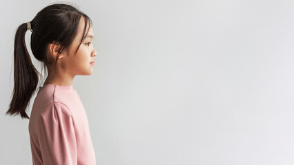 Profile Portrait Of Serious Asian Girl Looking Aside, Gray Background © Prostock-studio