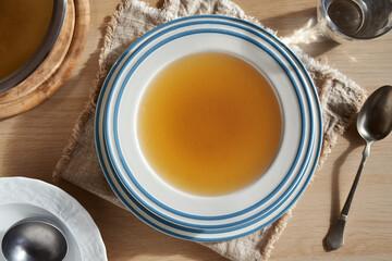 Obraz na płótnie Canvas Beef bone broth or soup in a soup bowl on a table