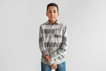 Fototapeta premium Serious Black Preteen Boy Looking At Camera Over Gray Background