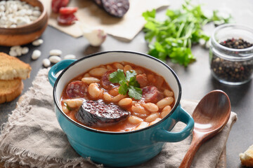 Asturiana traditional stew fabada with haricot, tomatoes, blood sausage. Close up. Spanish cuisine.