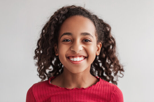 Headshot Of African American Girl Smiling Posing On Gray Background