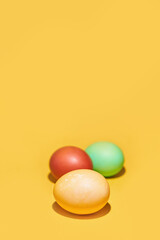 Painted Easter eggs on a yellow background. With space to copy. High quality photo