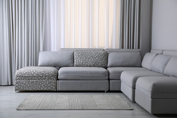 Large grey sofa in living room. Interior design