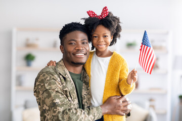 Portrait Of Happy Black Military Dad And His Daughter With American Flag