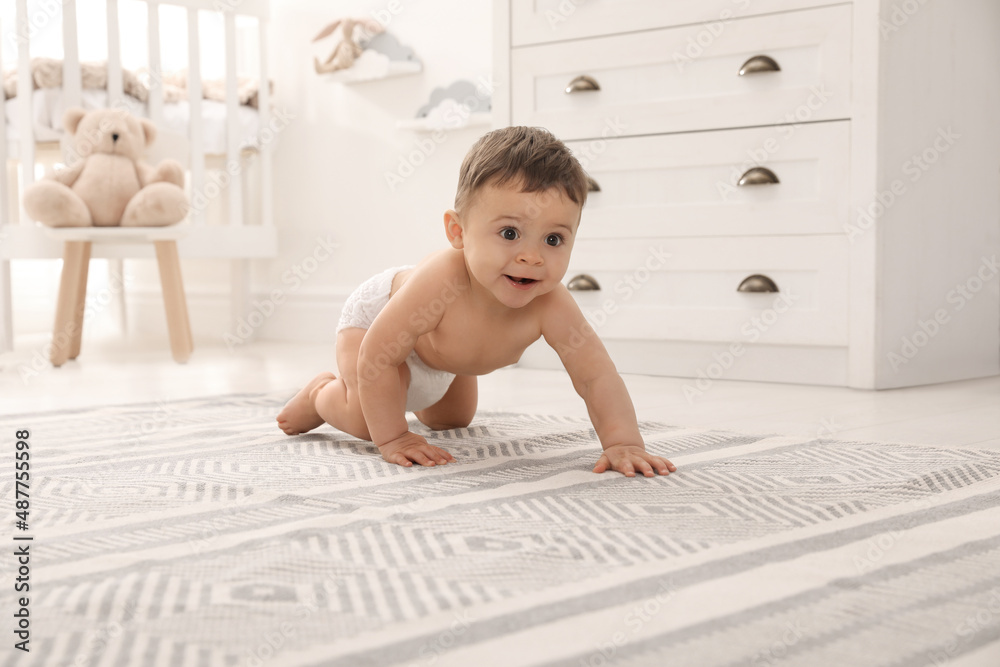 Wall mural cute baby crawling on floor at home