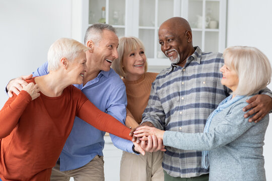 Multiracial group of senior people friends holding hands together