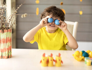 cute funny little boy with Easter painted eggs, easter concept