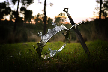 mysterious and magical photo of gold king crown and sword in the England woods. Medieval period concept.