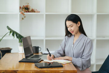 Beautiful Young Freelancer Woman Using Laptop Computer Sitting At Cafe Table. Happy Smiling Girl Working Online Or Studying And Learning While Using Notebook. Freelance Work, Business People Concept