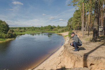 Man relax on the river bank.