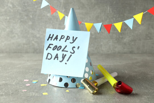 Concept of April Fool's Day on gray textured table