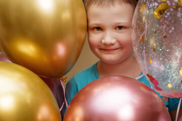 Boy smiling in front of balloons