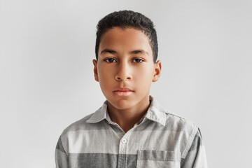 Obraz premium Headshot Of Serious African American Preteen Boy On Gray Background